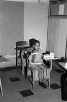 Young girl eating lunch at a school desk