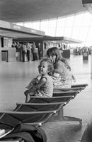 Girls sitting in Washington Dulles International Airport, Dulles, Virginia