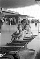 Young girls sitting in Washington Dulles International Airport, Dulles, Virginia