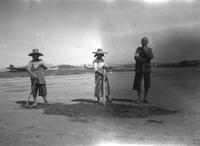 Three workers repairing a runway, U.S. Army Air Corps base near Kunming, China (August 1945)