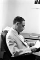 Herb Striner in profile sitting at a desk