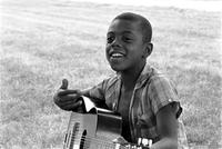 Child with guitar at the Potomac School as part of the Adams-Morgan Community Council's Potomac Summer Project, McLean, Virginia