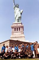 American and Chinese table tennis teams posing in front of the Statue of Liberty in New York harbor