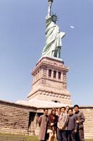 American and Chinese table tennis players standing at foot of Statue of Liberty in New York harbor