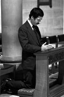 Man praying while kneeling in church