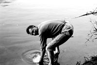 Terrence Jackson cleaning mess kit in Deep Creek Lake, Maryland (Summer, 1963)