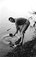 Terrence Jackson cleaning mess kit in Deep Creek Lake, Maryland (Summer, 1963)