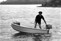Young man steering a motor boat on Chesapeake Bay, Maryland