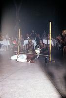 Man in white pants performing the limbo