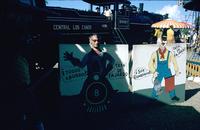 Herb Striner posing behind cardboard cutout in front of train, Puerto Rico