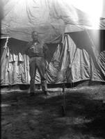 First Lt. Myers in front of a tent, Camp Kanchrapara (Winter 1946)