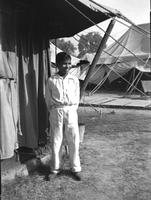 A young boy standing outside of a tent, Camp Kanchrapara, Bengal, India (Winter, 1946)