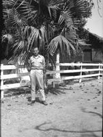 First Lt. Myers in front of a palm tree, Camp Kanchrapara (Winter 1946)