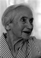 Profile portrait of an elderly woman wearing a striped dress