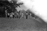 Children and teachers outside in a field at the Potomac School as part of the Adams-Morgan Community Council's Potomac Summer Project, McLean, Virginia