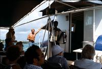An accordionist entertains passengers on the deck of a boat, Bermuda