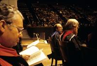 Dean Thomas Buergenthal (left) seated on stage with others at a commencement ceremony at American University, Washington, D.C.