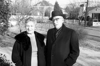 Man and woman posing outside in winter clothes
