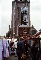 Façade of the Nieuwe Church, statue, and open-air market at Plaza Markt, Delft, Netherlands