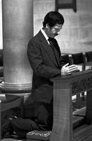Kneeling man praying in church