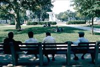 Friends sitting on bench in Dupont Circle in Washington, D.C.