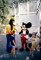 Mickey Mouse and Goofy interact with visitors in Disneyland, Anaheim, California
